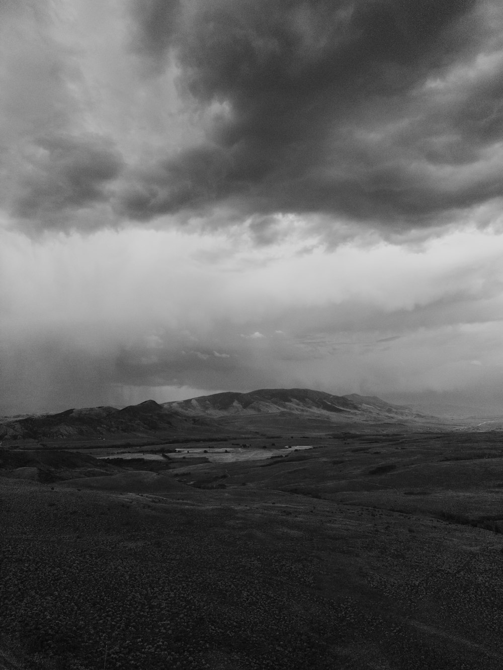 a landscape with hills and clouds