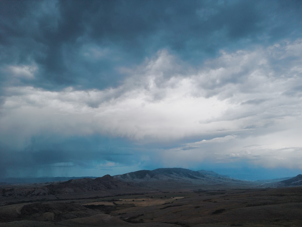 a landscape with mountains in the back