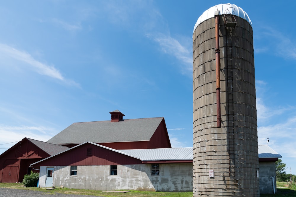 a large silo next to a building