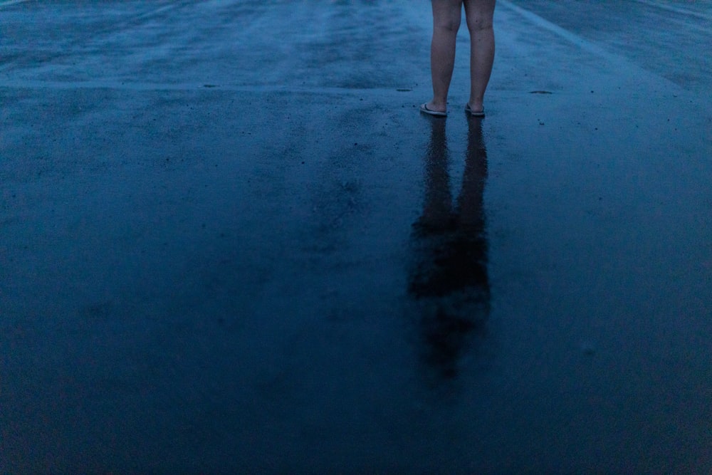 a person's legs and feet in the sand