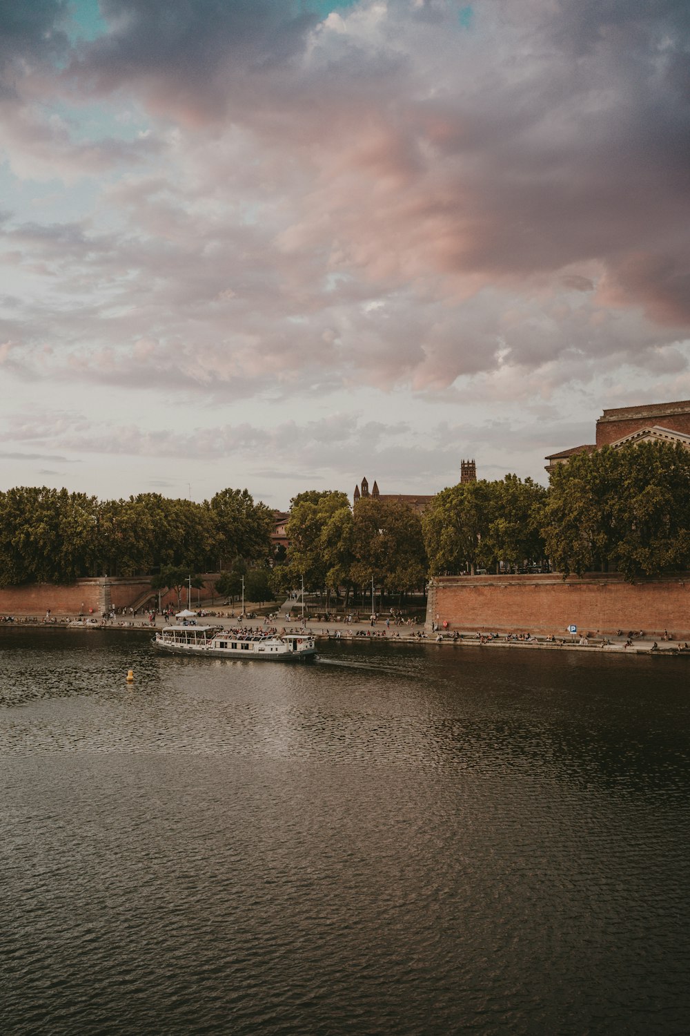 a body of water with boats in it and trees around it