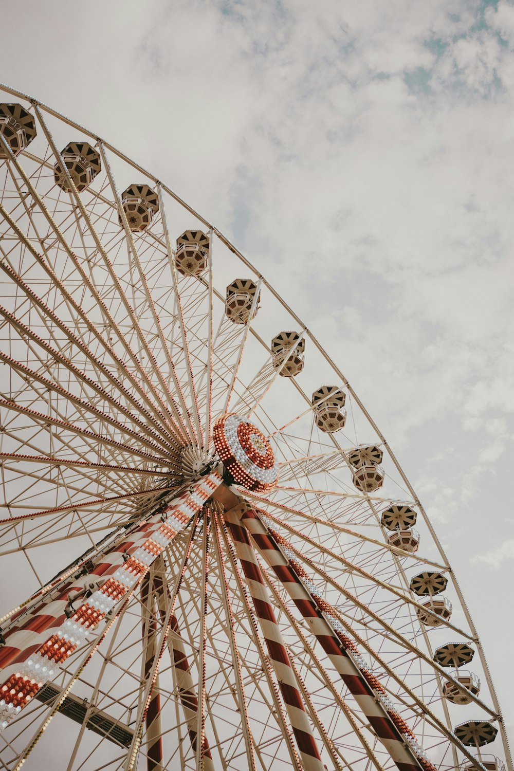 a ferris wheel with a cloudy sky