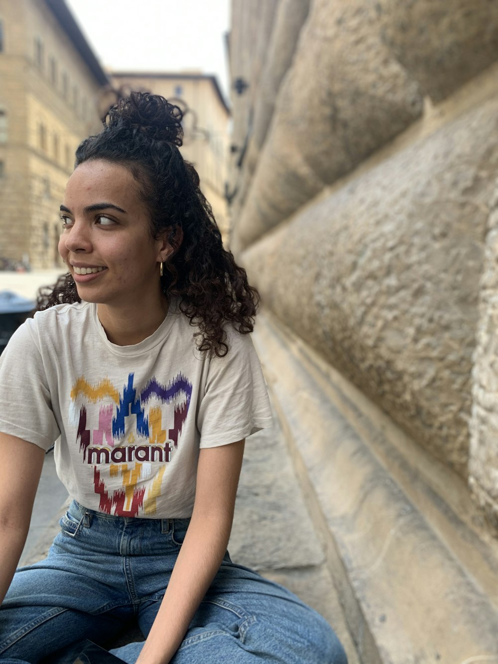 a person sitting on a ledge