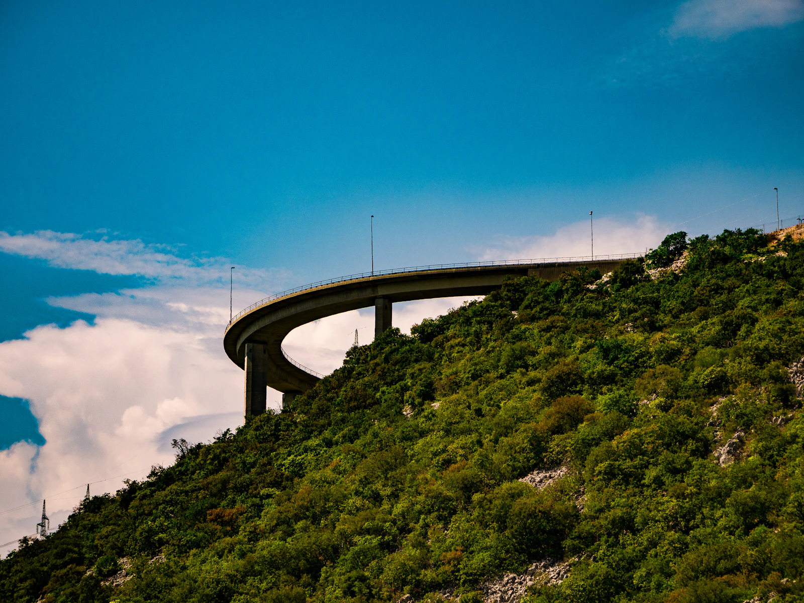 Croatian motorway curves along a steep green hillside