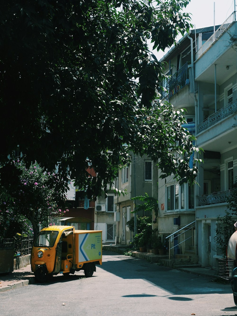 a yellow truck parked on the side of a street