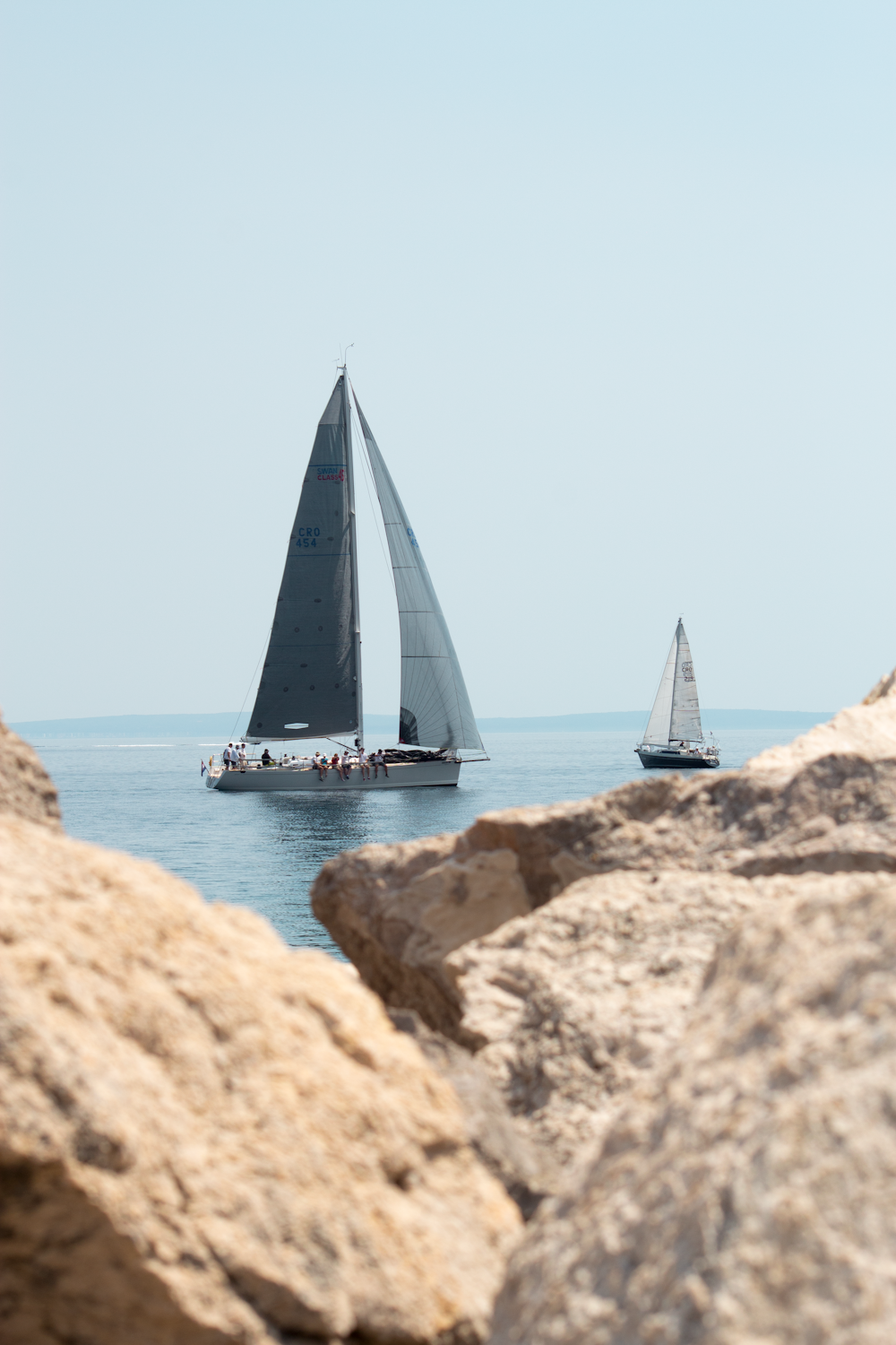 a couple of sailboats on the water