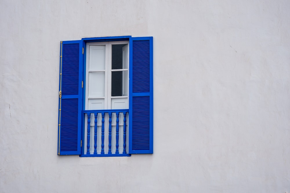 a window with blue shutters
