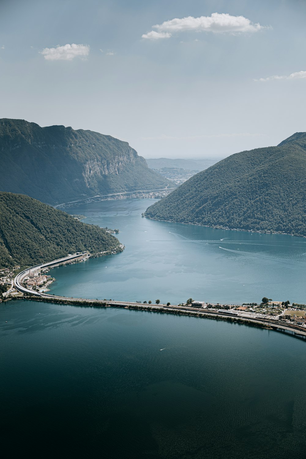 a body of water with a bridge and a city by it