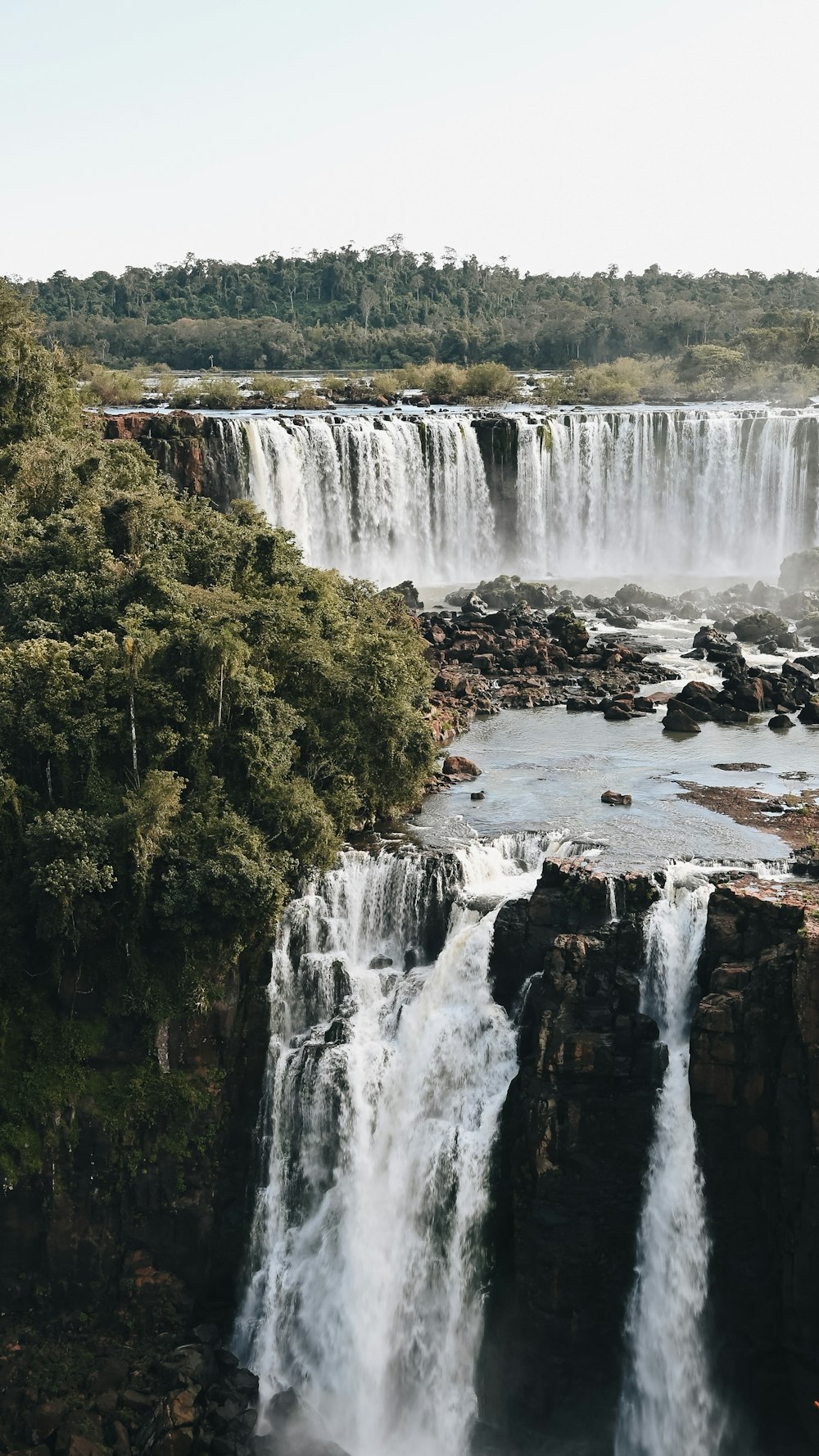 a waterfall with trees and rocks