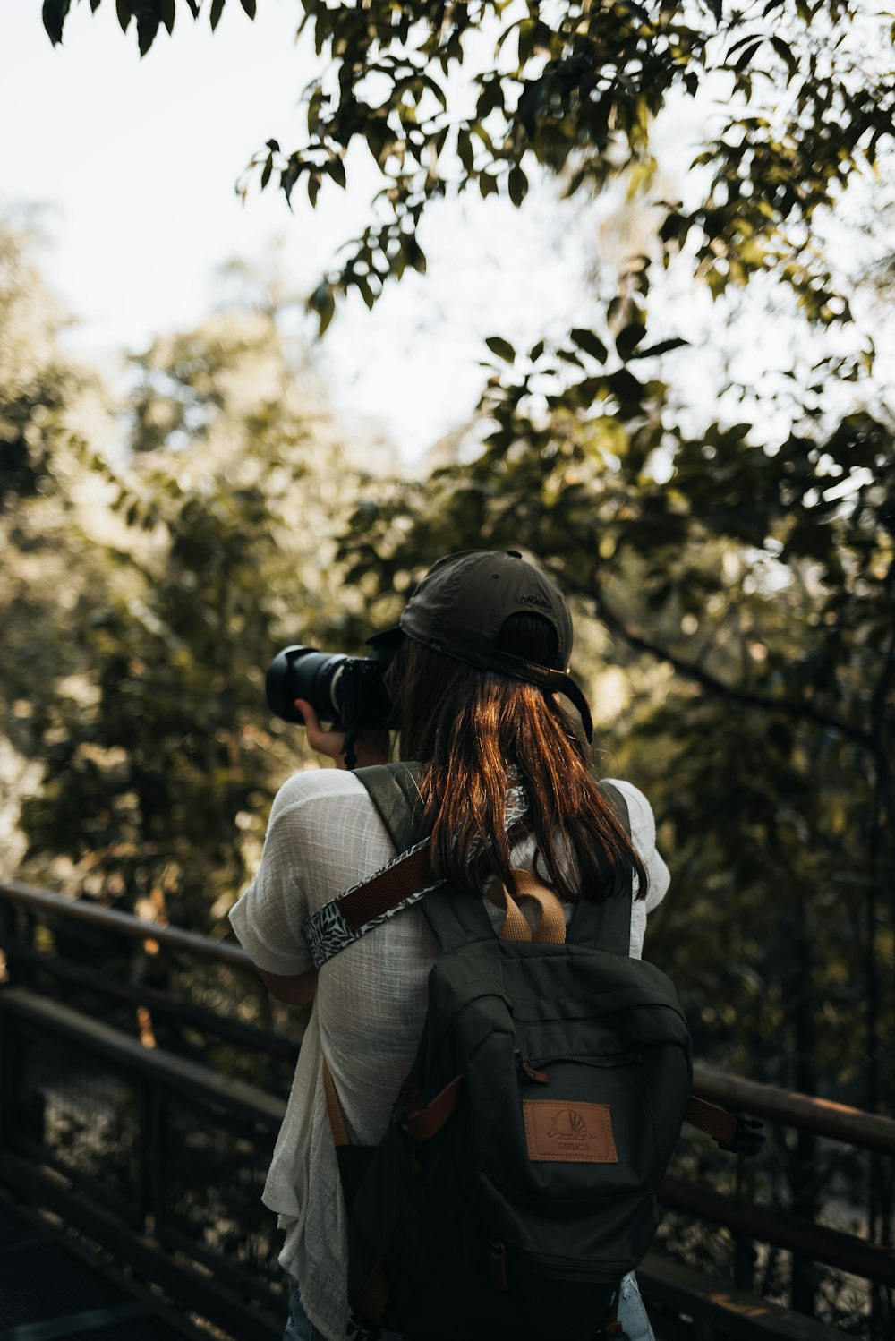 a woman with a camera on her head looking through a scope