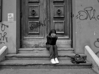 a person sitting on steps outside a building
