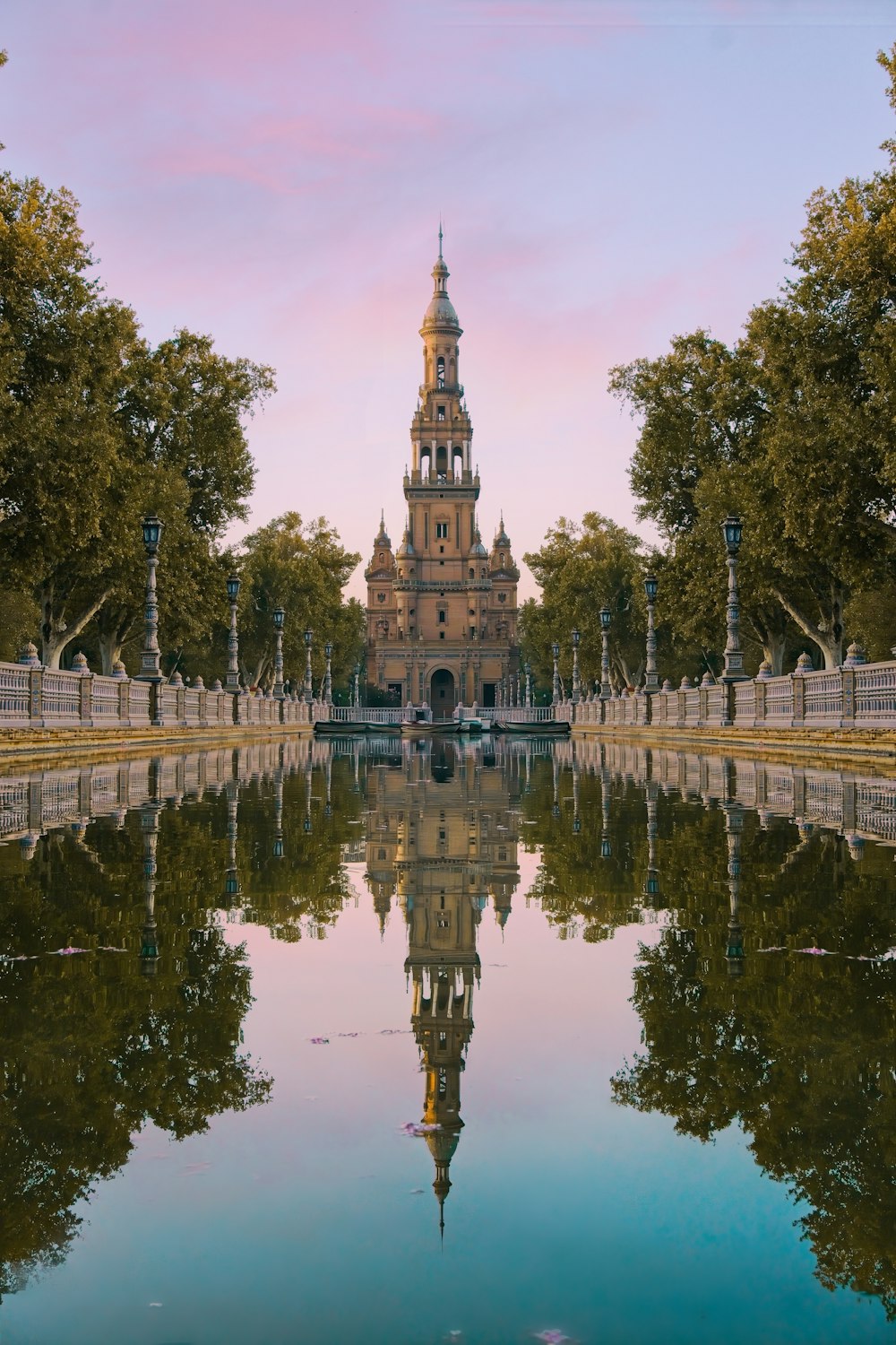 a building with a tower and trees around it