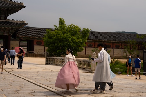 A group exploring a traditional Korean hanok village during a themed tour.