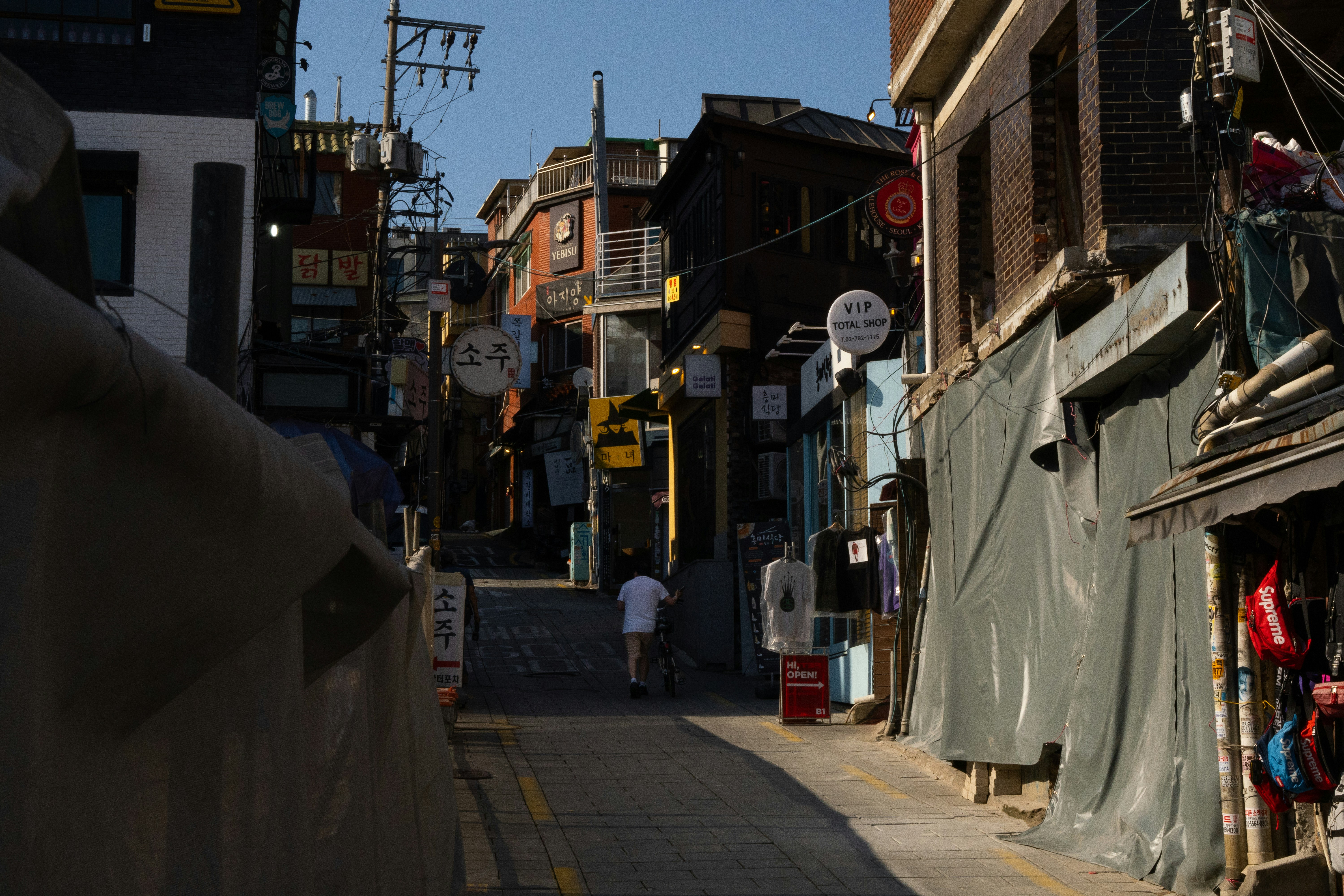 a person walking down a narrow street