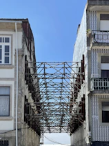 a metal gate between buildings