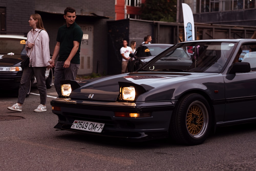 a black car with a surfboard on the hood