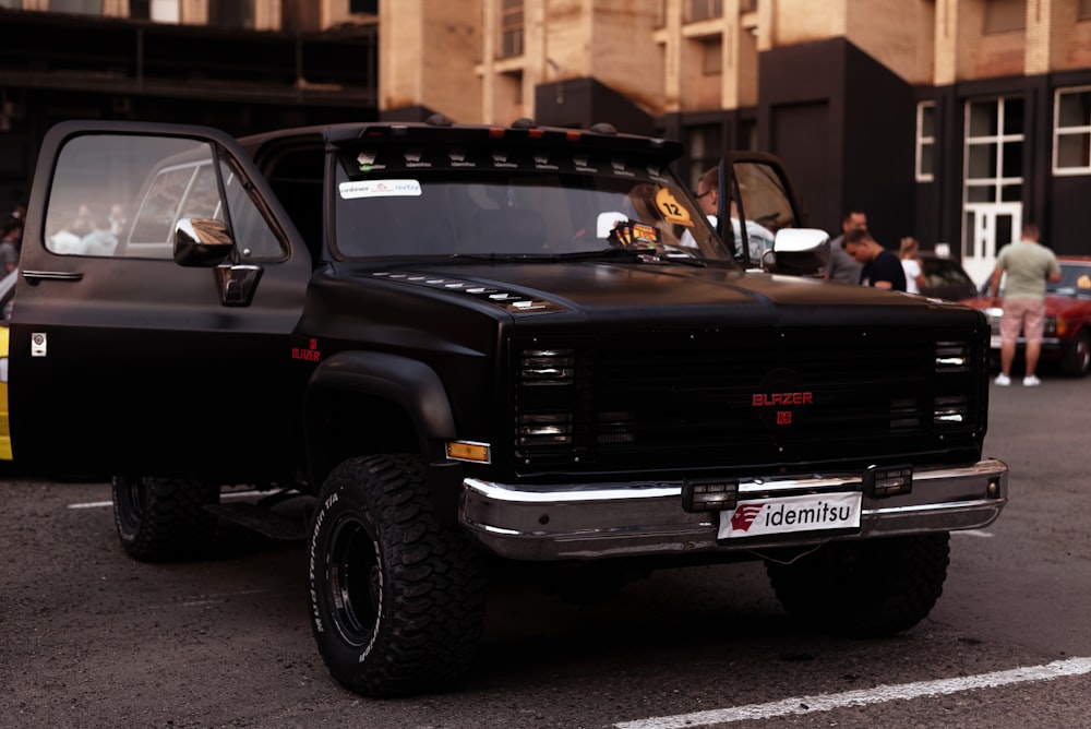 a black truck parked in a parking lot