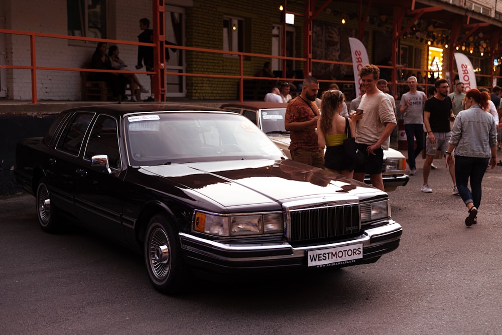 a car parked on a street with people walking around