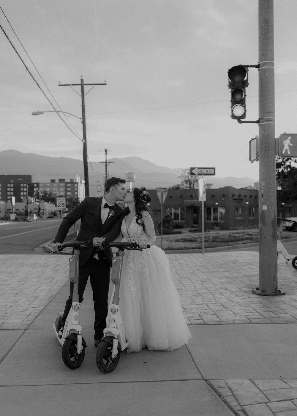 a bride and groom on a bicycle