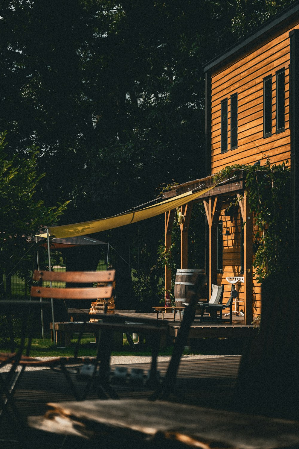 a wooden swing set in front of a house