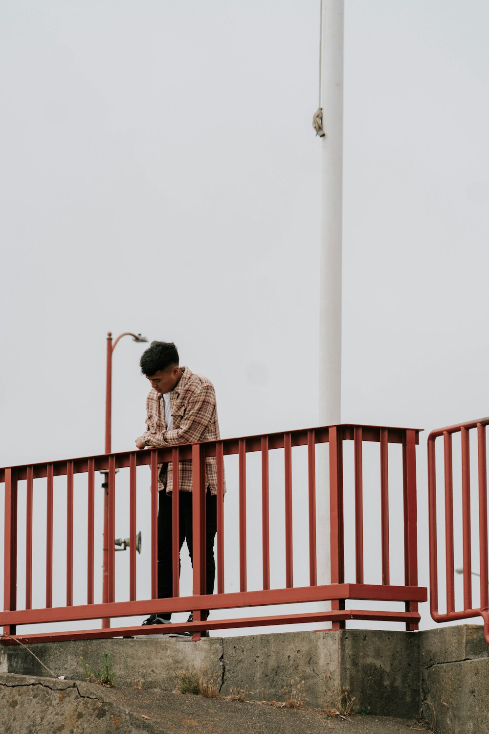 a man standing on a red railing
