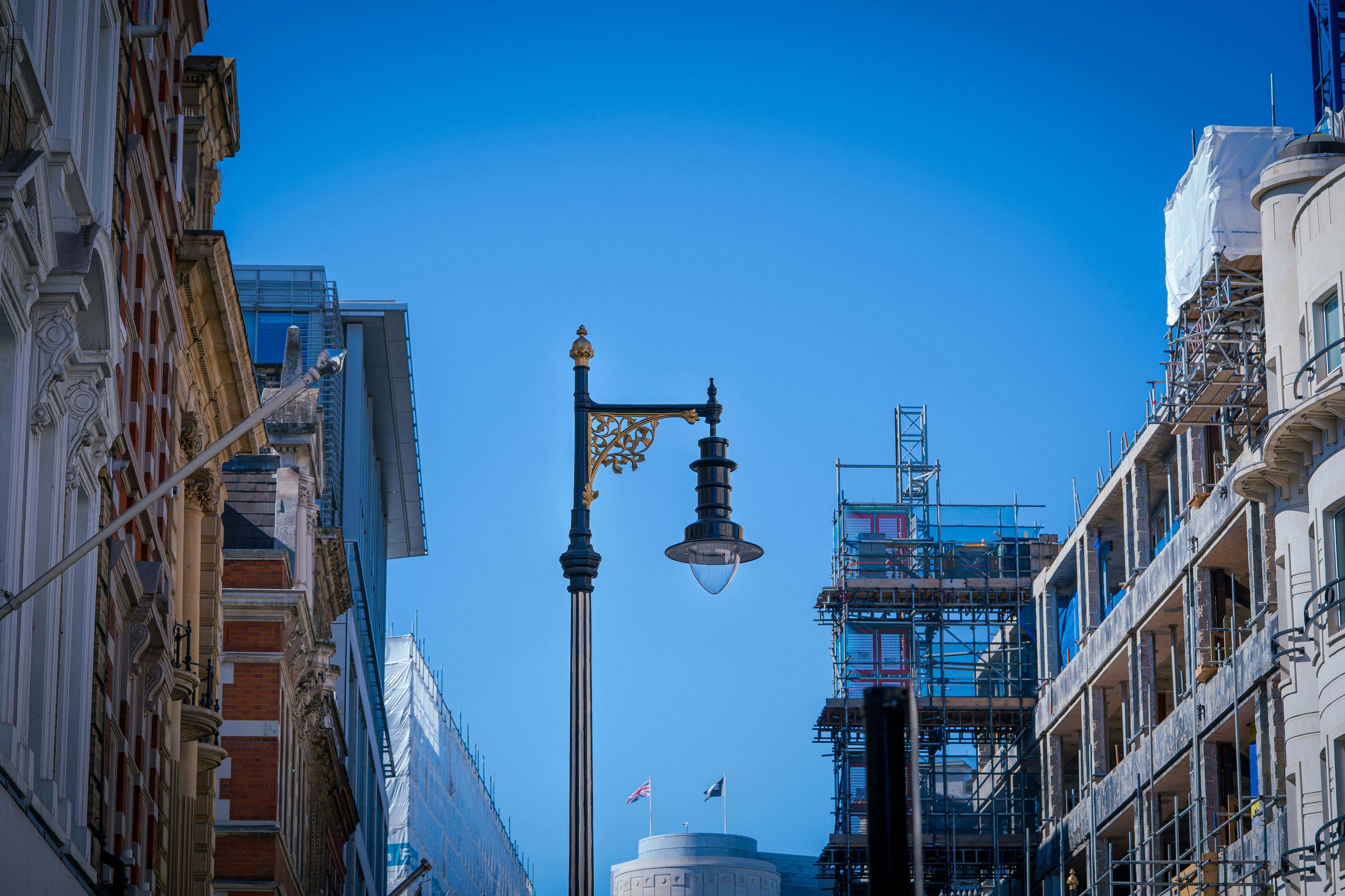 a city street with buildings and a ferris wheel