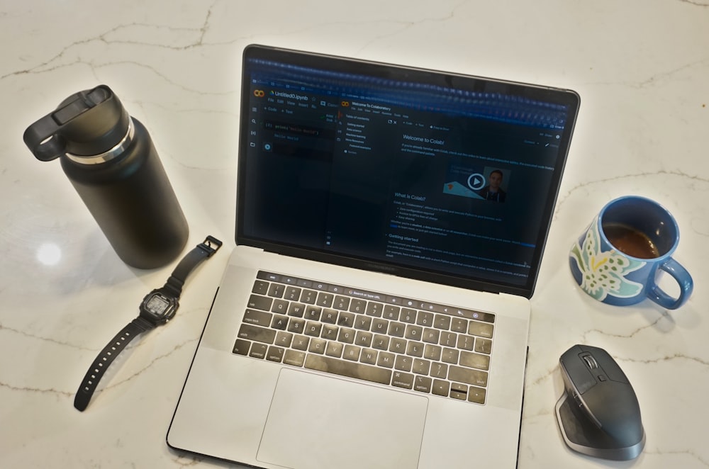 a laptop and coffee mug