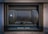 A secure metal box embedded into the wall, labeled 'Night Safe.' It has a sturdy and slightly worn appearance, with evident use and weathering.