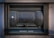 A secure metal box embedded into the wall, labeled 'Night Safe.' It has a sturdy and slightly worn appearance, with evident use and weathering.