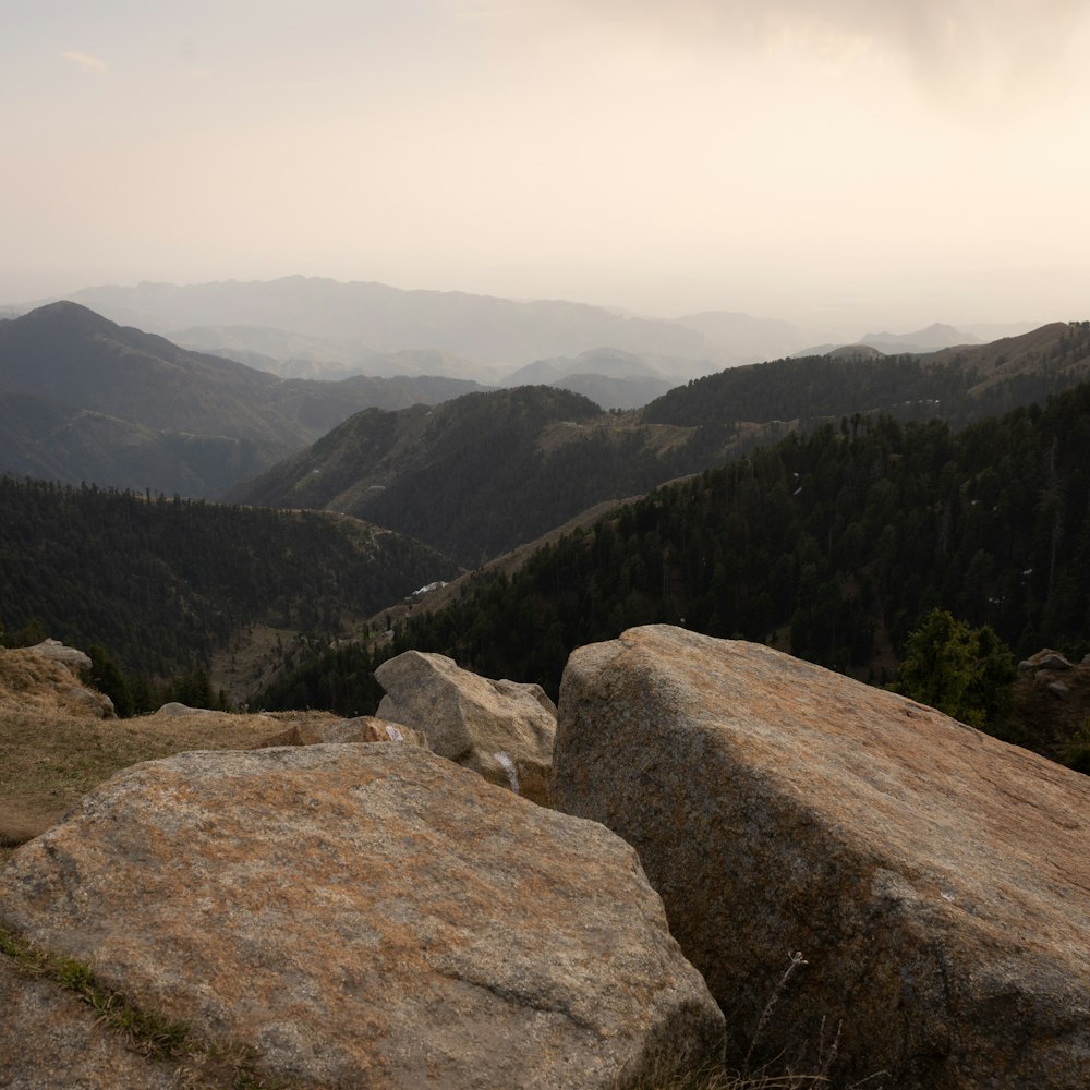 a rocky landscape with mountains in the background