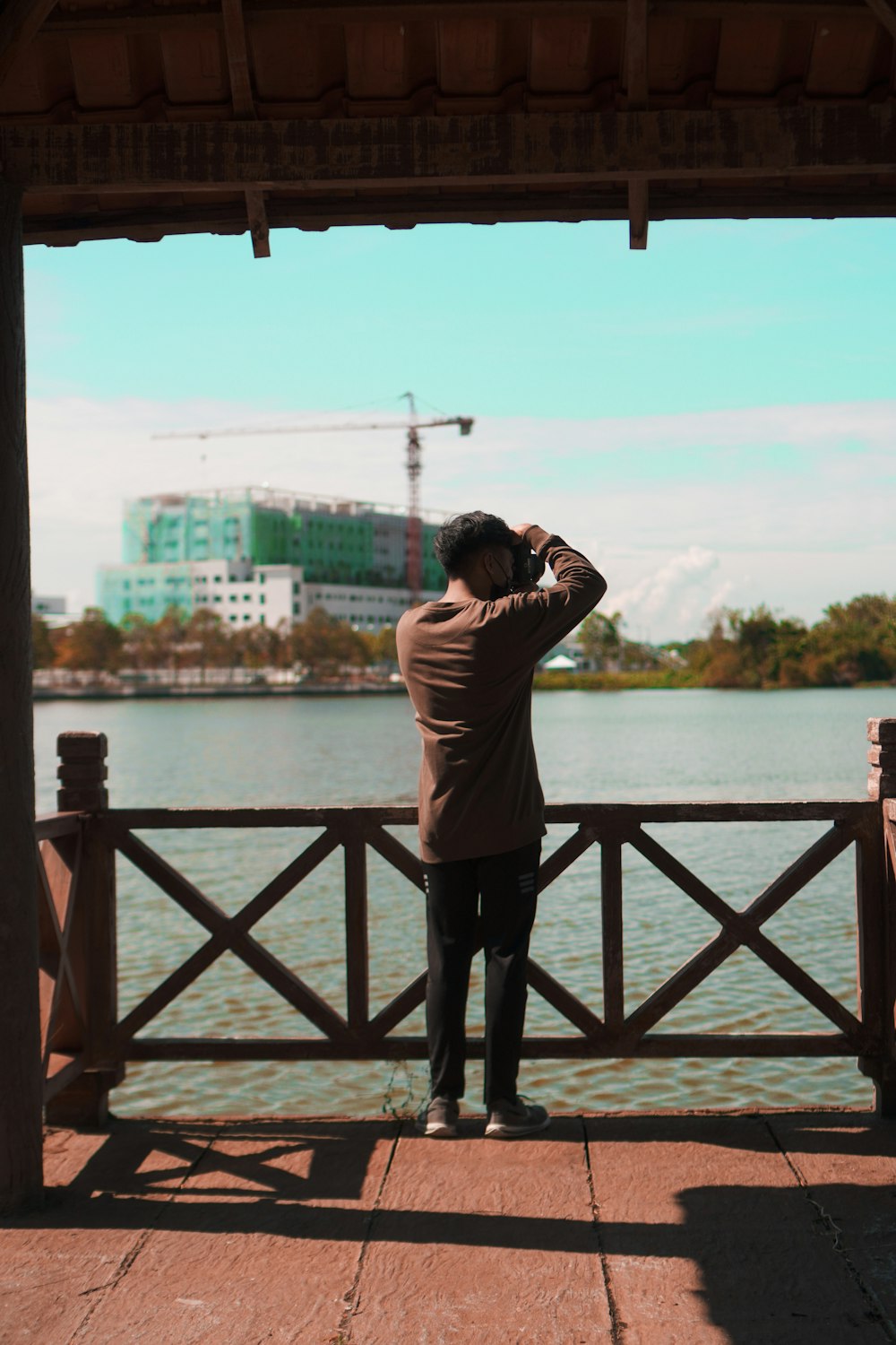 a person taking a picture of a bridge