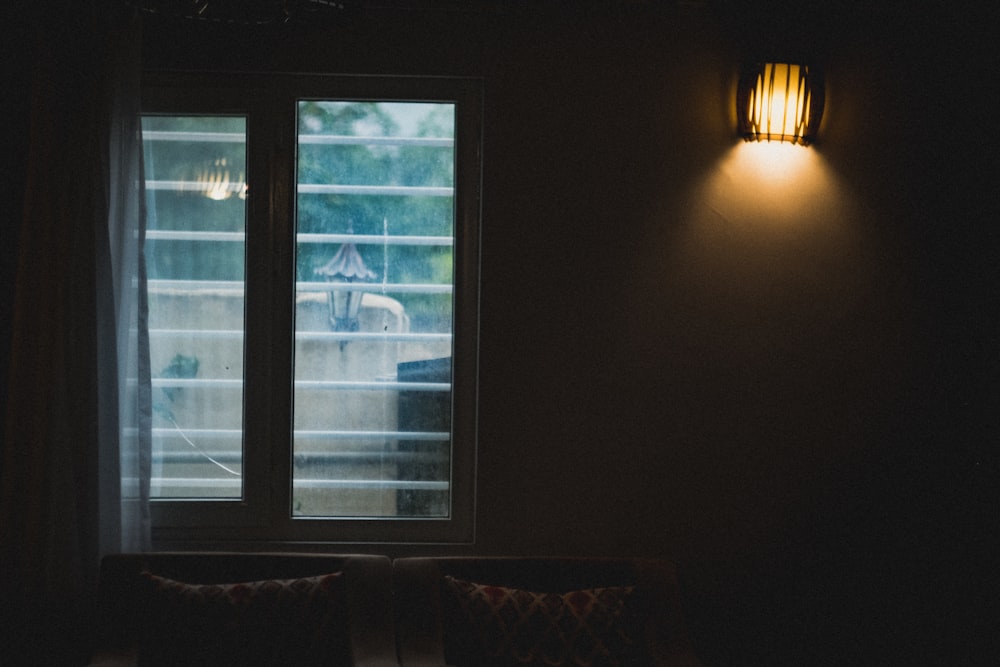 a window with a view of a boat in the water