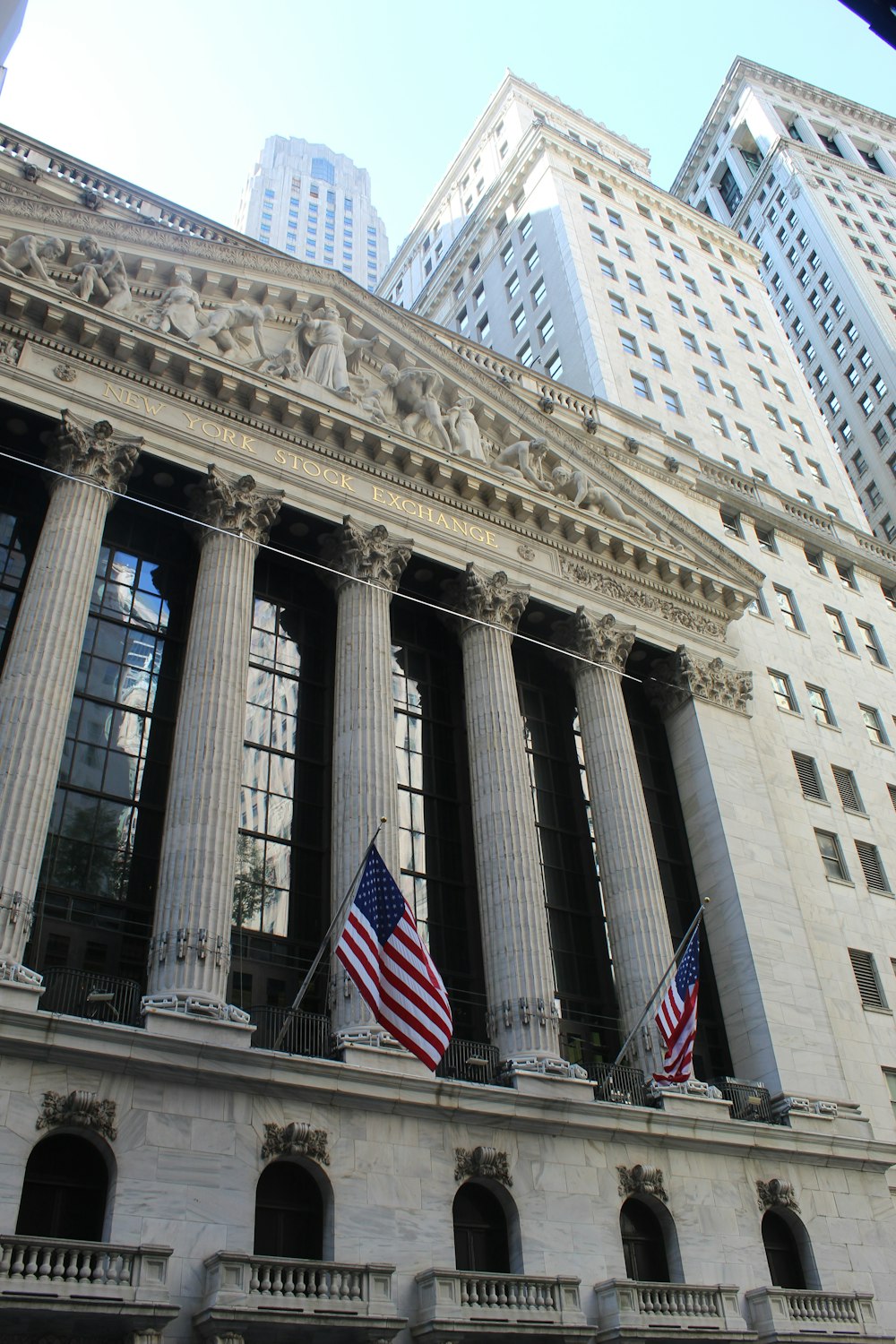 Federal Hall with columns and a flag