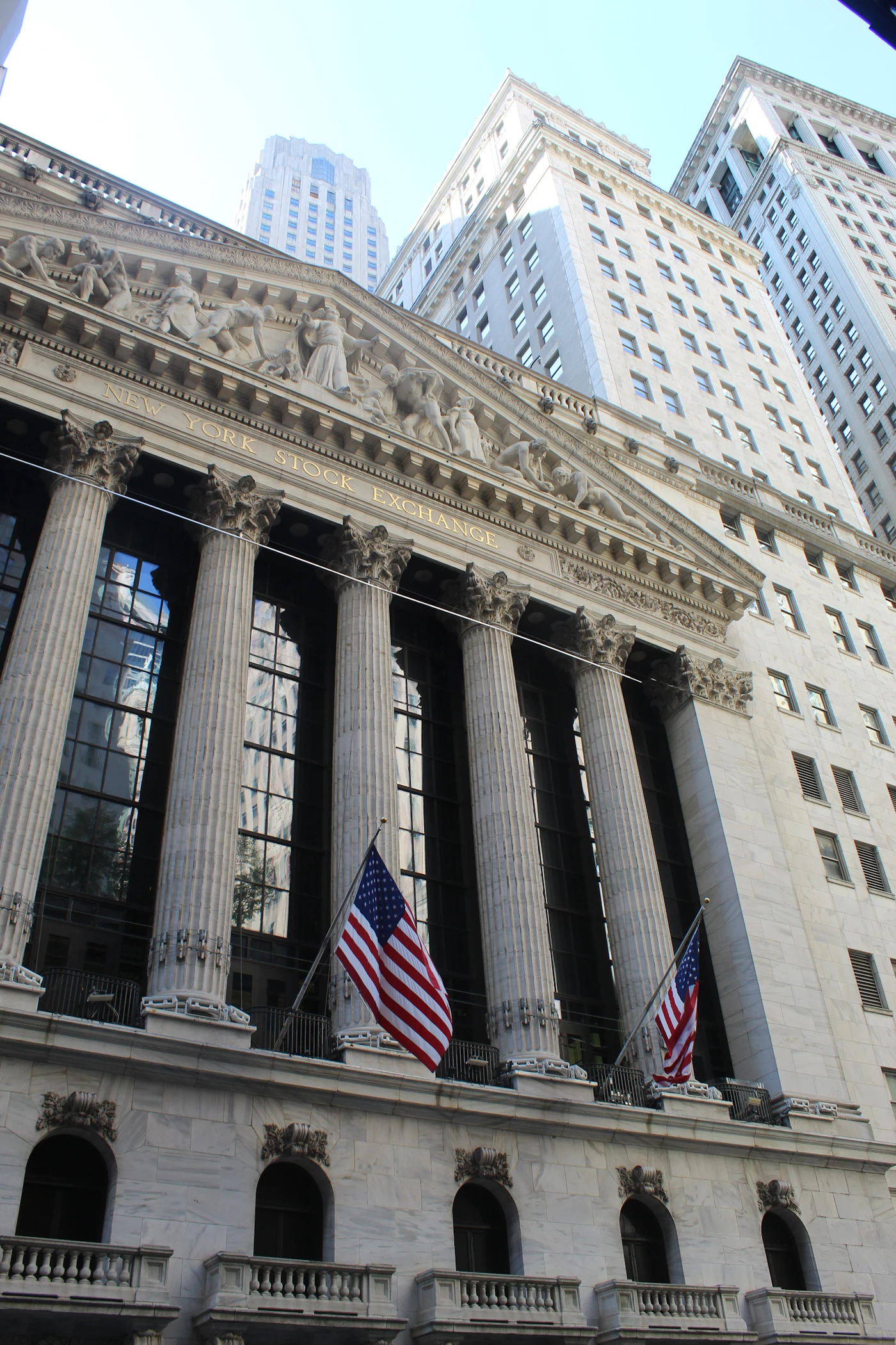 Stone columns of Federal Hall in New York with an American flag hanging between them