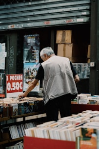 a man standing in front of a book shelf