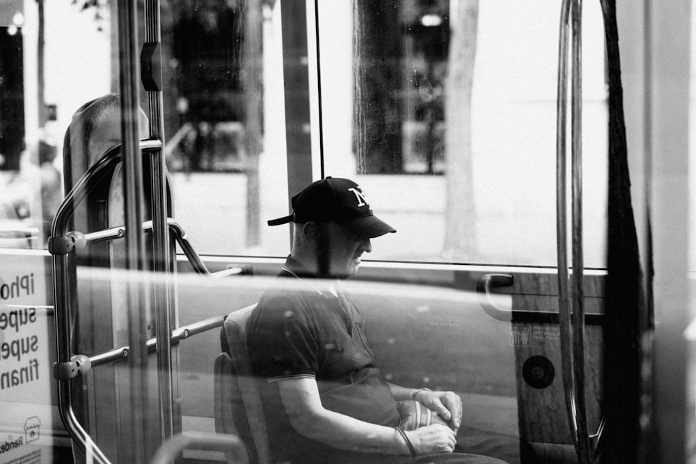 a person in a hat sitting in a bus