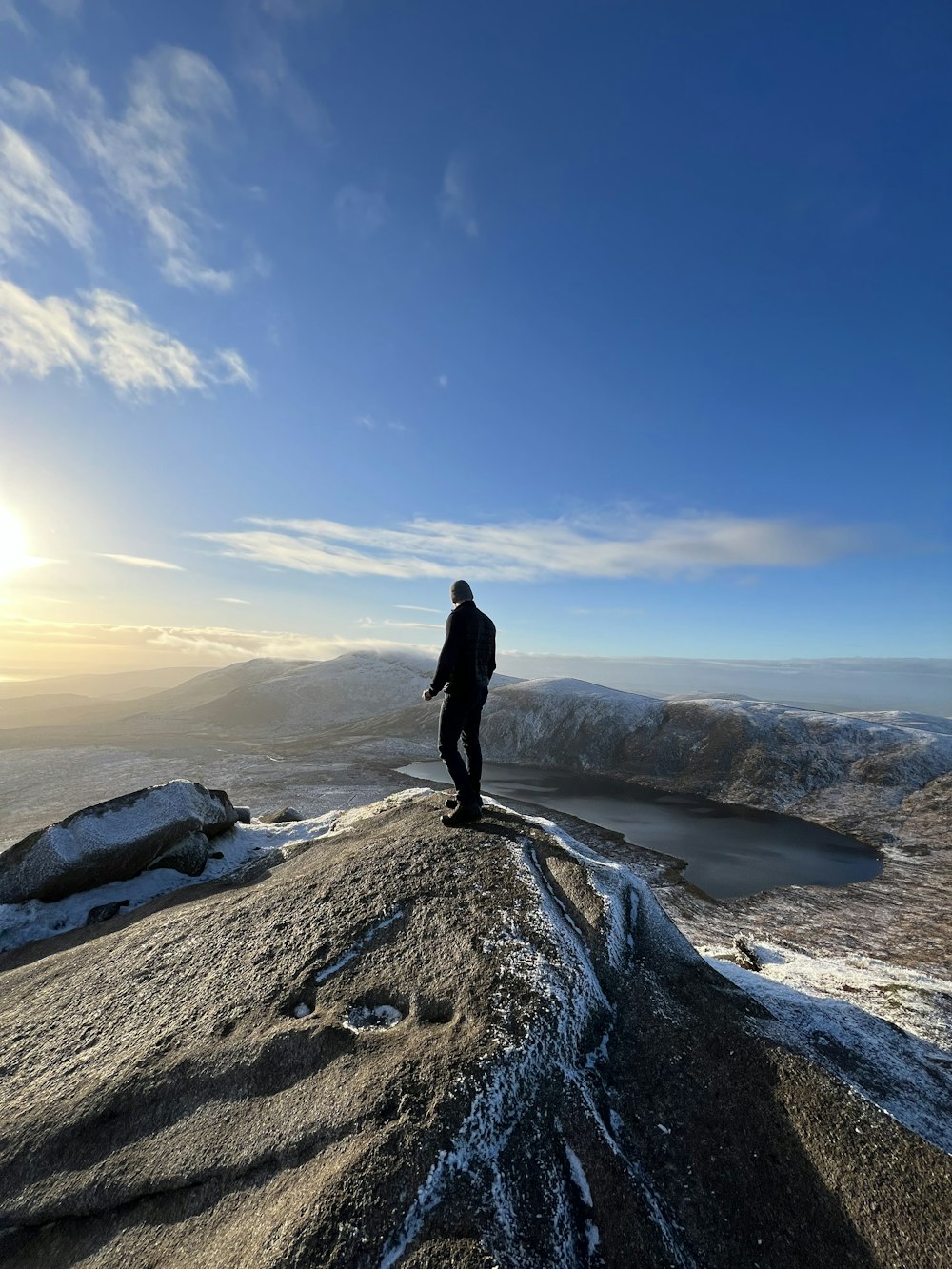 a man standing on a rocky hill