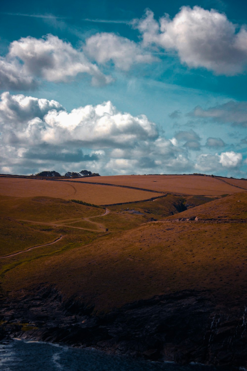 a landscape with hills and clouds