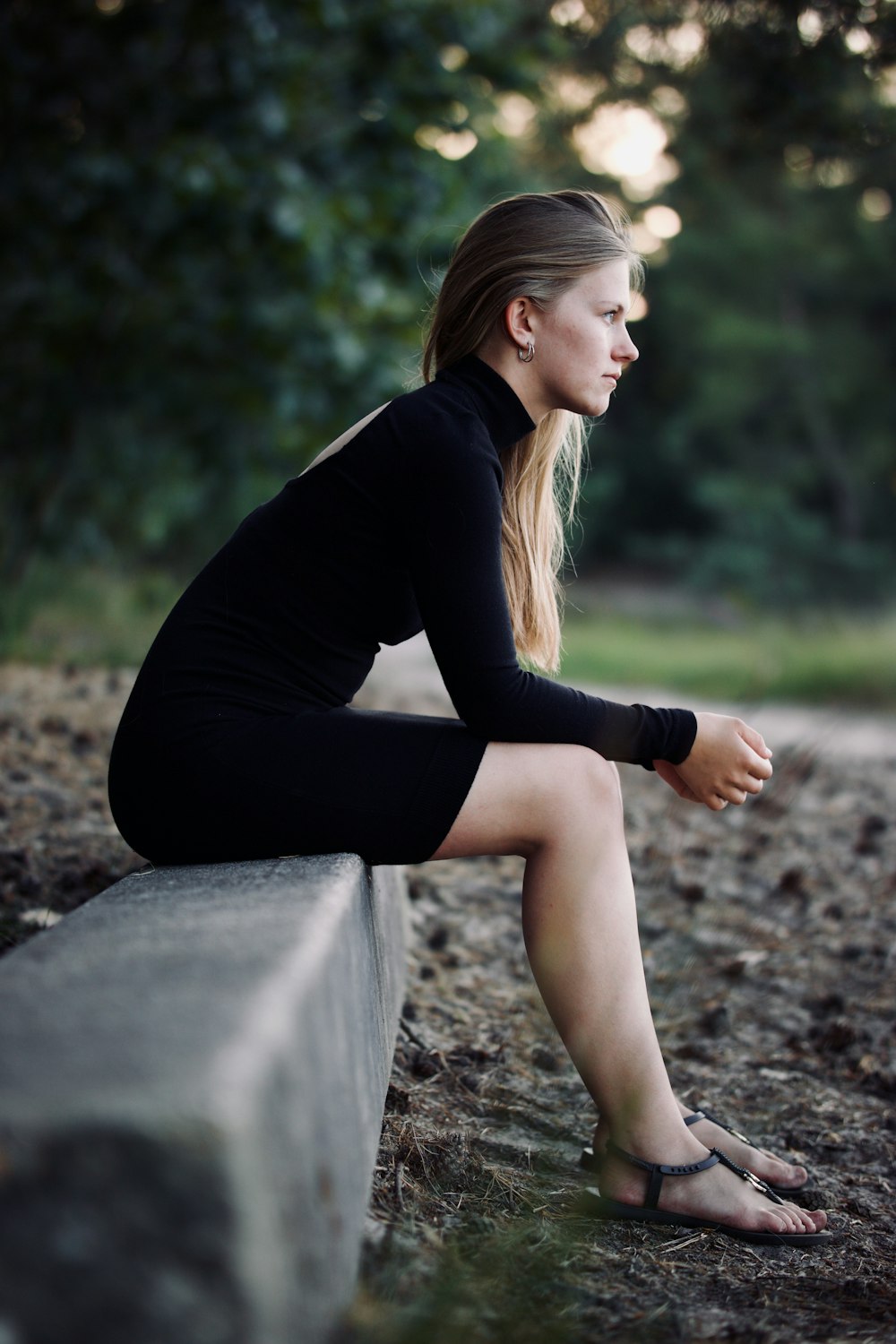 a woman sitting on a rock