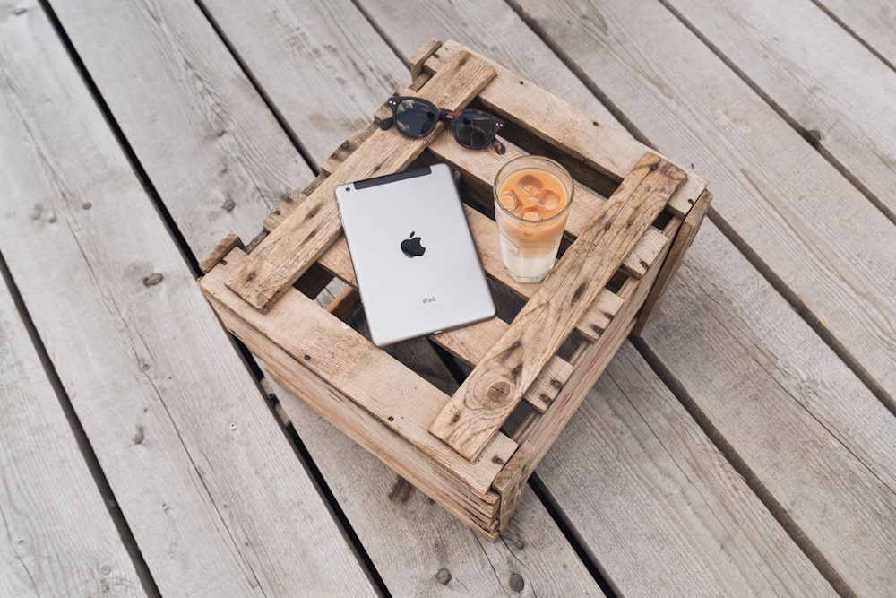 a cell phone and a cup of coffee on a wooden table