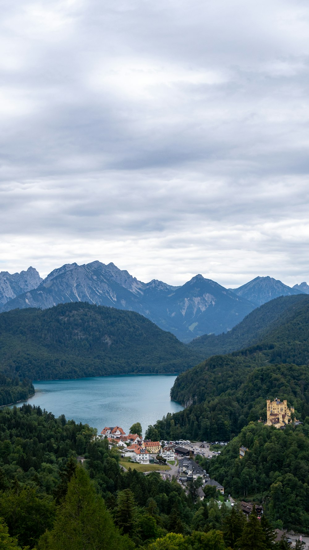 a town by a lake with mountains in the background