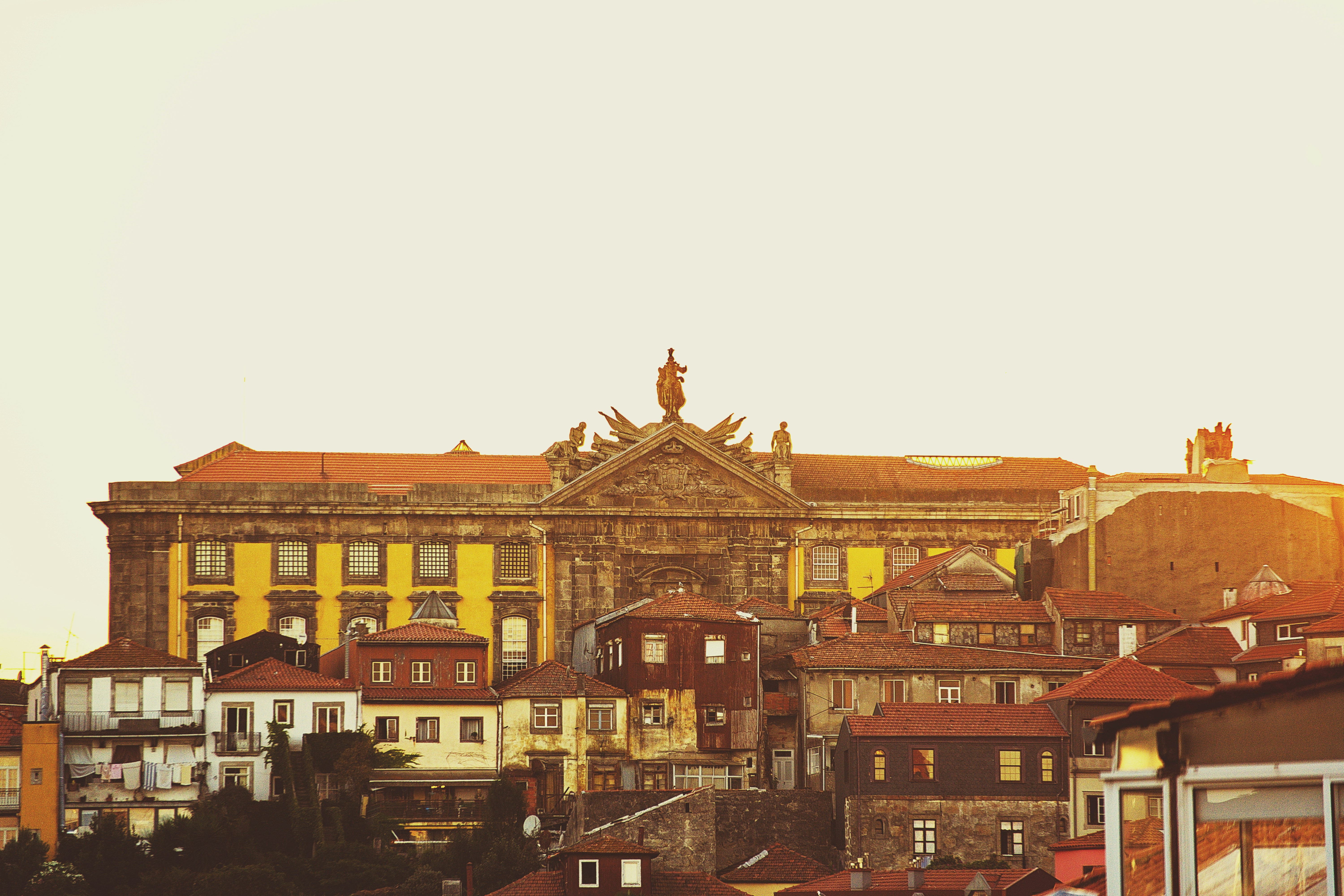 a group of buildings with a statue on top