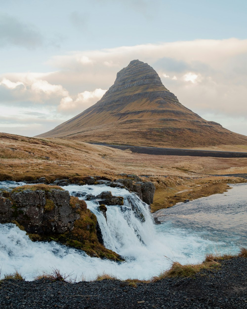 a mountain with a body of water in front of it