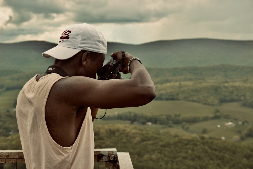 a person taking a picture of a valley