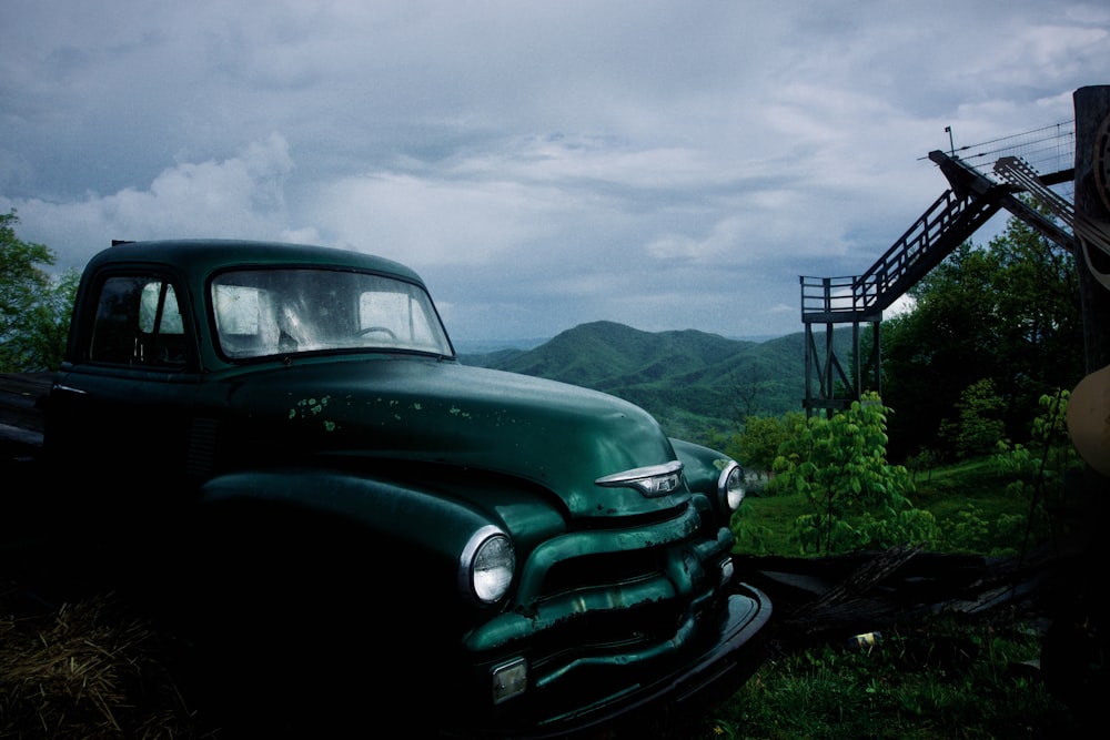 a green truck parked in a field