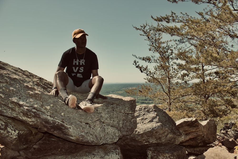 a man sitting on a rock