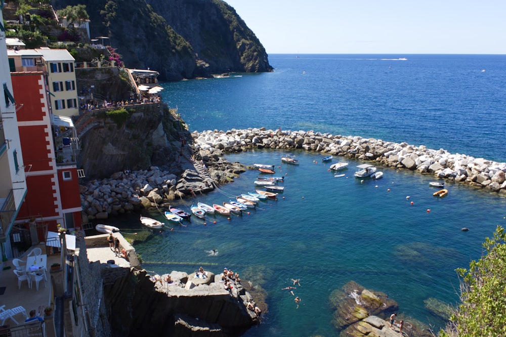 a body of water with a rocky shoreline and a building