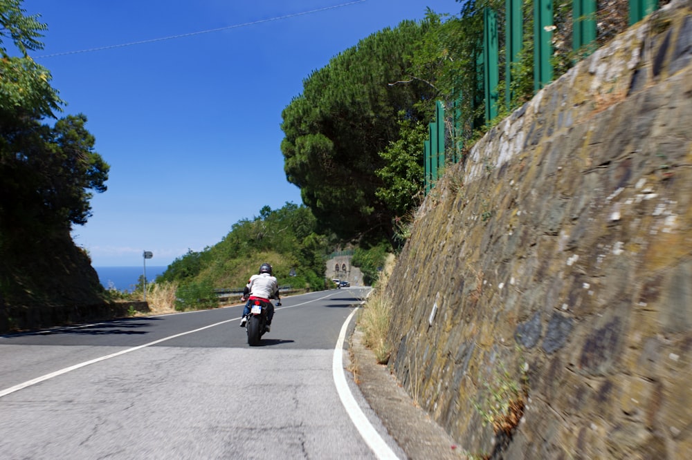 a person riding a motorcycle down a road