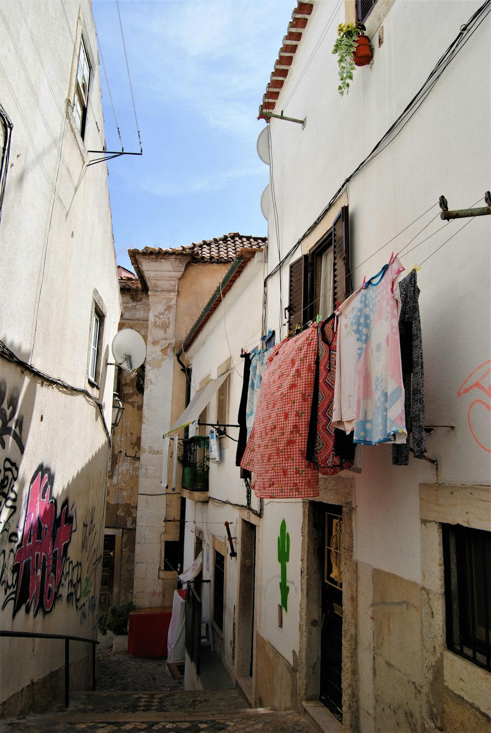 a row of buildings with clothes