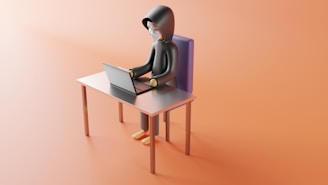 a person sitting at a desk with a laptop on it